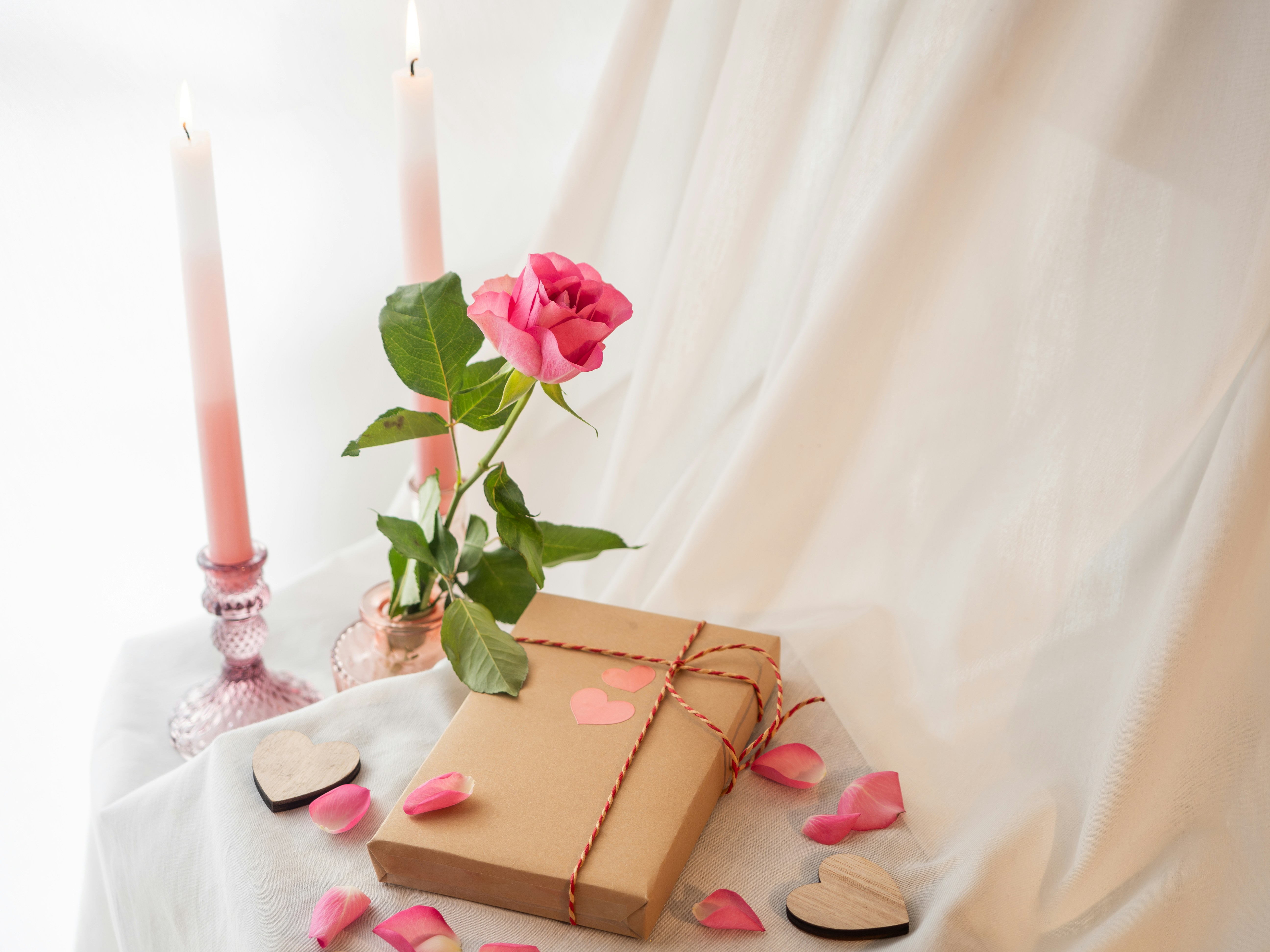 image of wrapped gift with a rose and candles